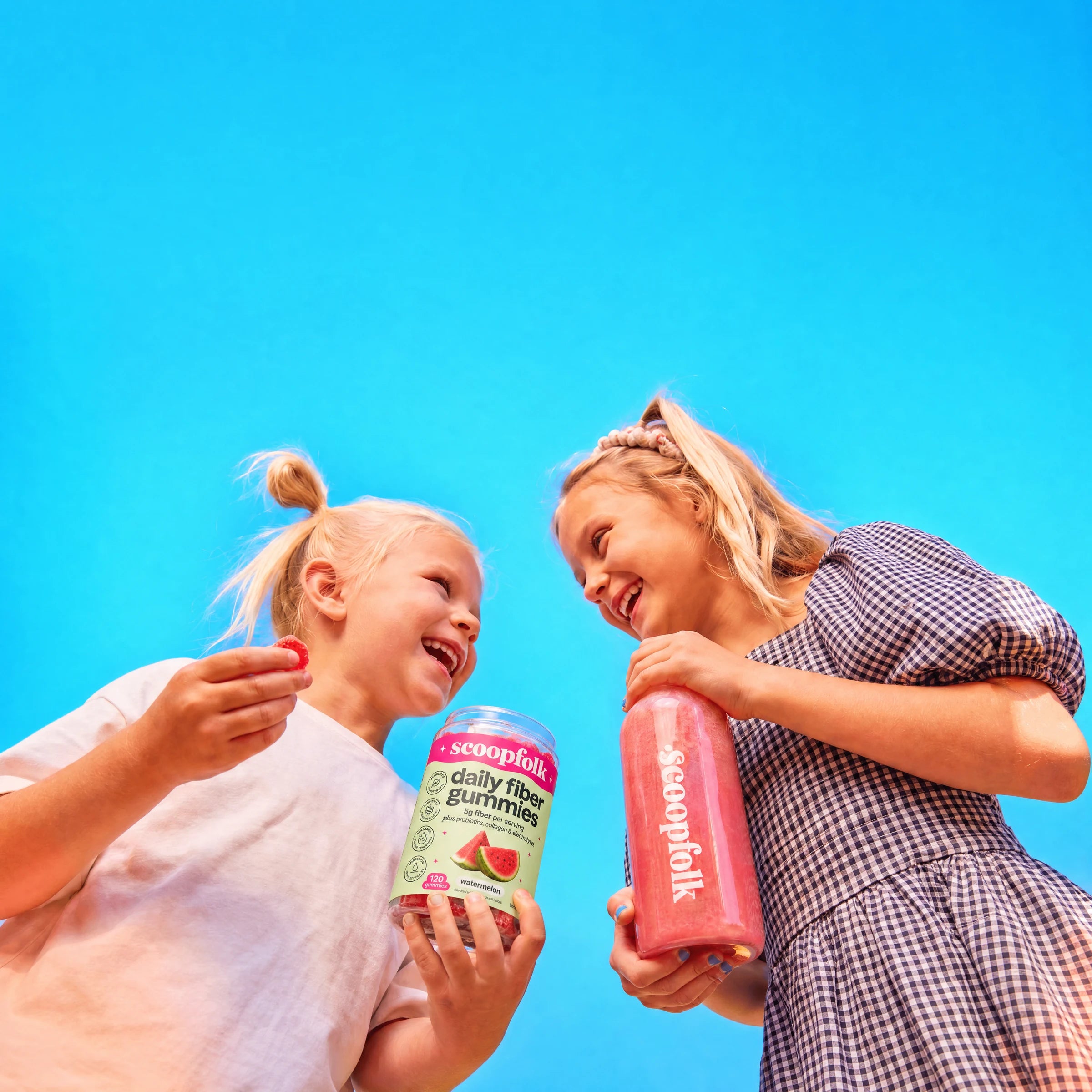 Family enjoying Scoopfolk gummies and a pink drink